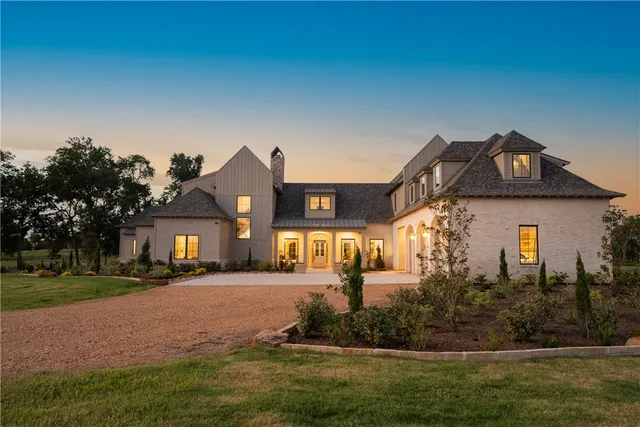 a front view of a house with a big yard
