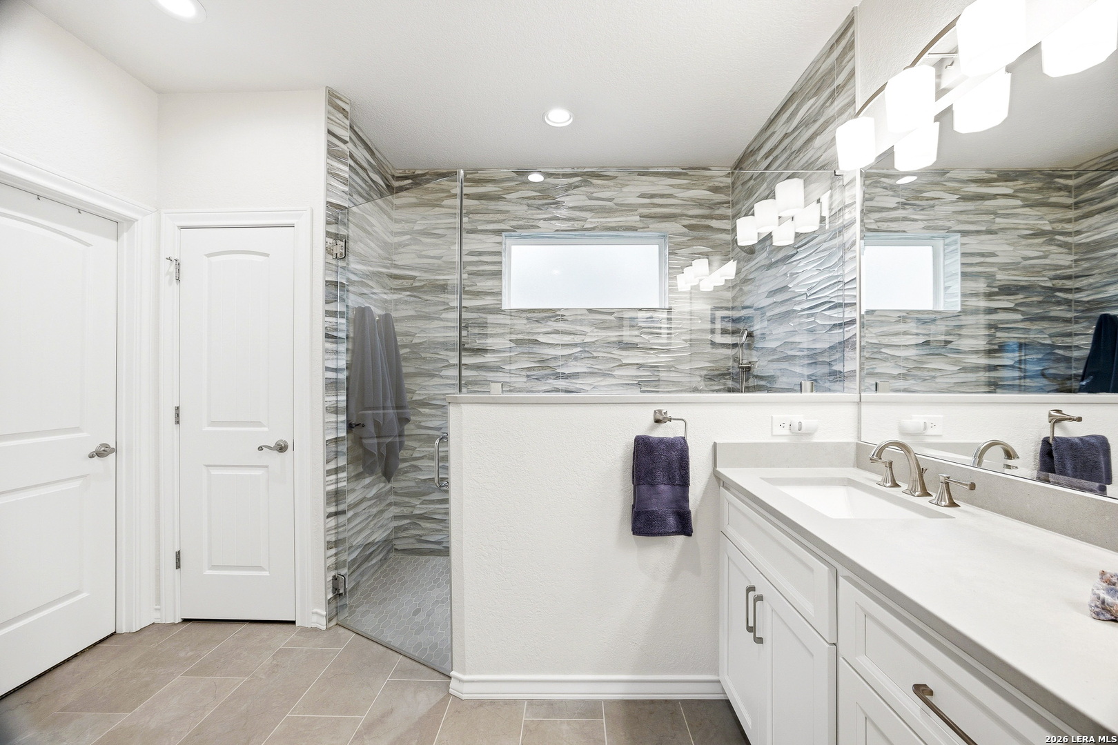 541 Saxet Trail Spring Branch, TX 78070 - Photo 23 of 59 a bathroom with a sink a mirror and shower