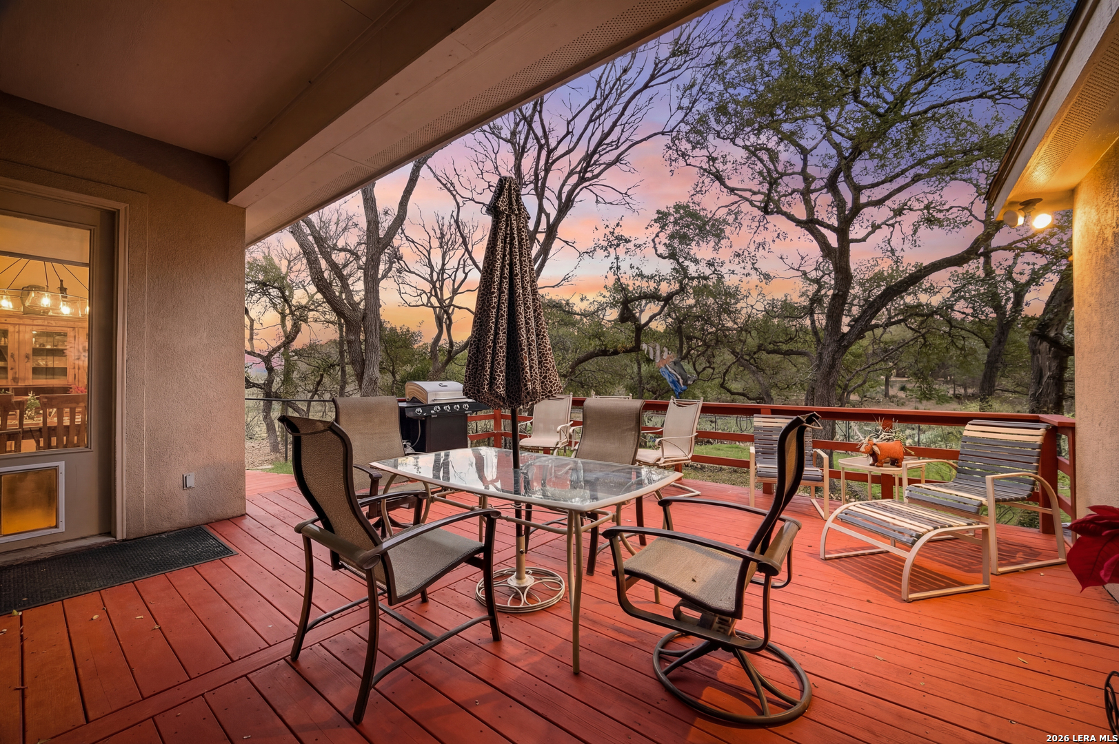 541 Saxet Trail Spring Branch, TX 78070 - Photo 31 of 59 a view of a patio with table and chairs with wooden floor and fence
