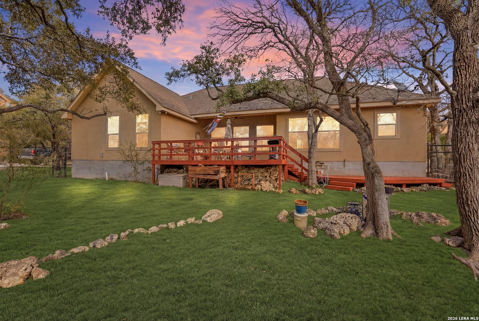 541 Saxet Trail Spring Branch, TX 78070 - Photo 35 of 59 a front view of a house with a garden and trees