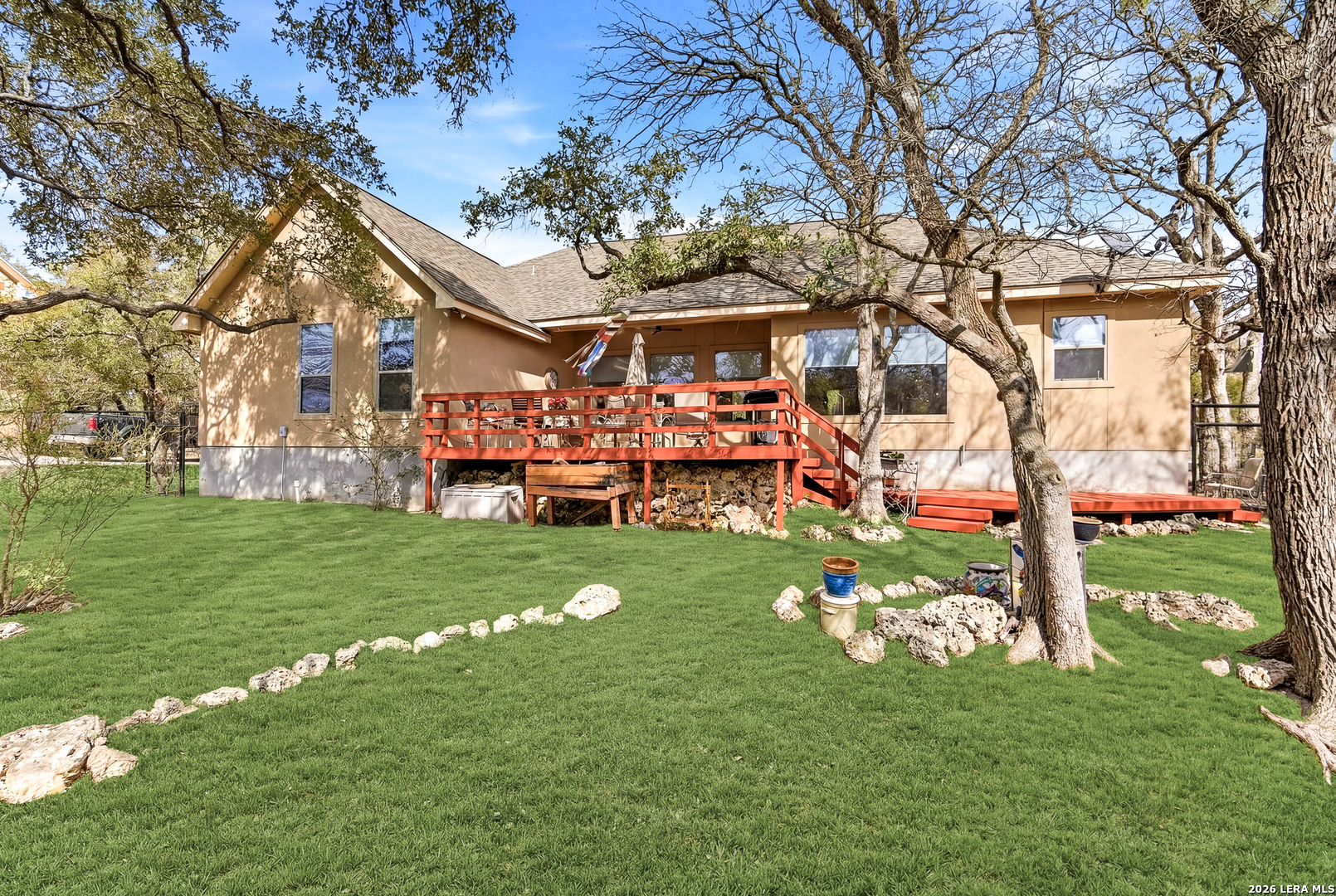 541 Saxet Trail Spring Branch, TX 78070 - Photo 36 of 59 a front view of a house with a garden and trees