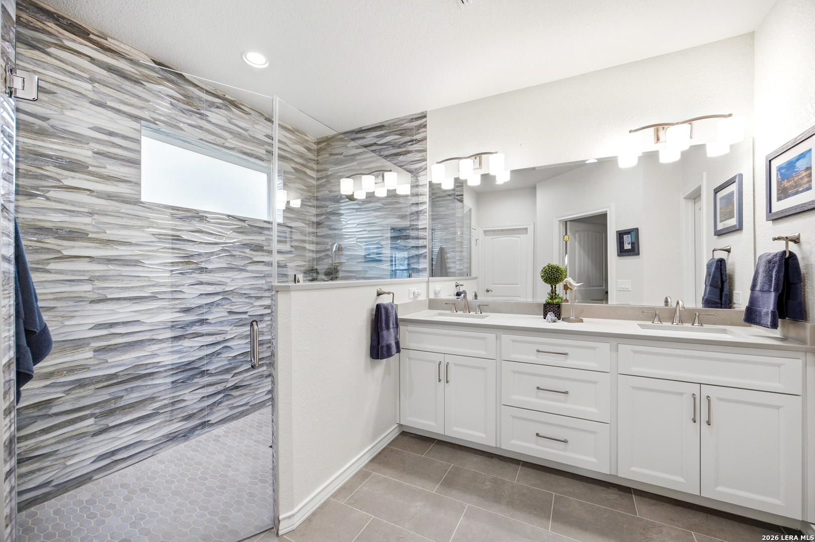 541 Saxet Trail Spring Branch, TX 78070 - Photo 5 of 59 a bathroom with a sink a mirror and a shower