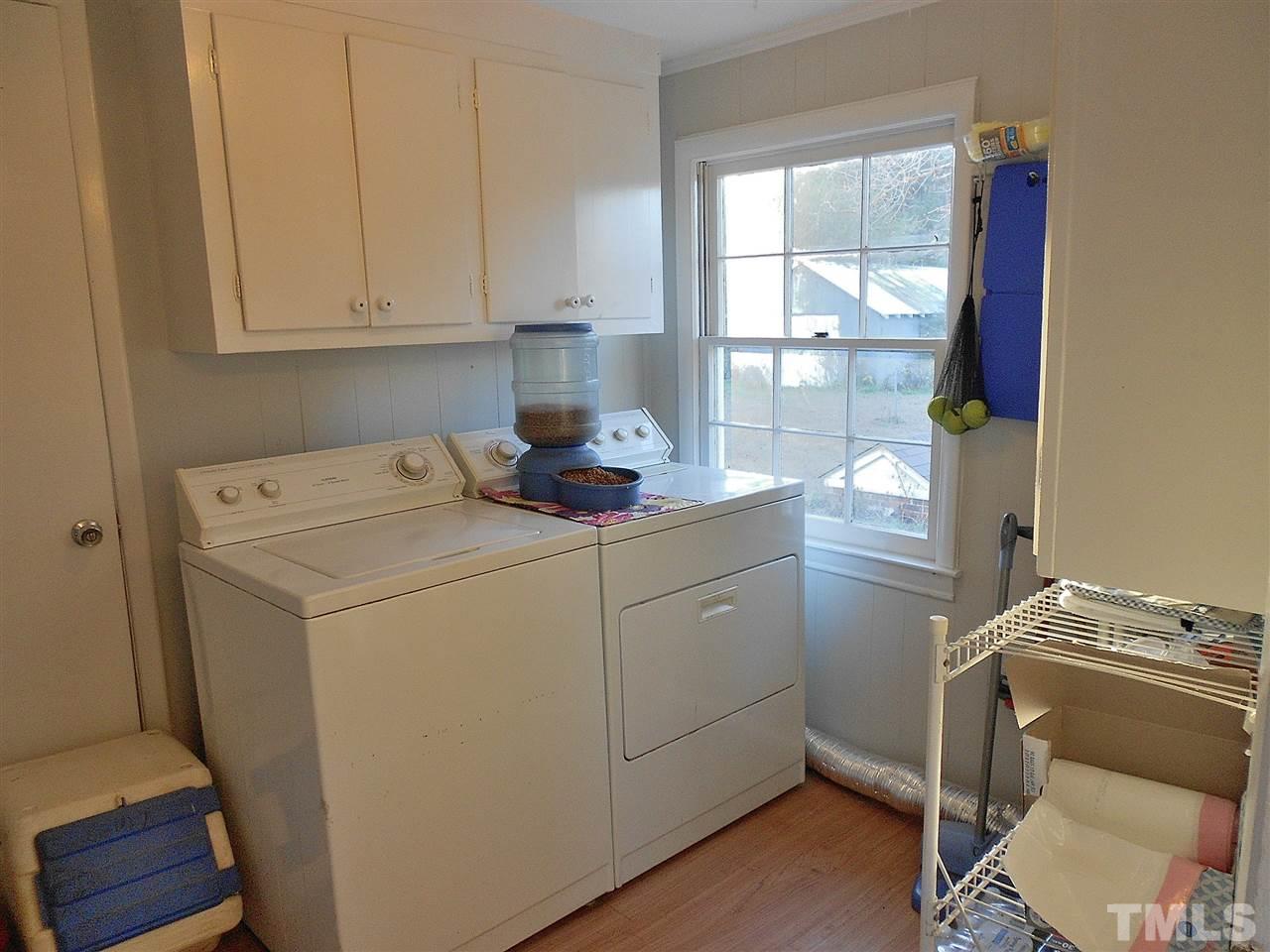 9408 Walter Myatt Road Fuquay-Varina, NC 27526 - Photo 11 of 25 a utility room with cabinets washer and dryer