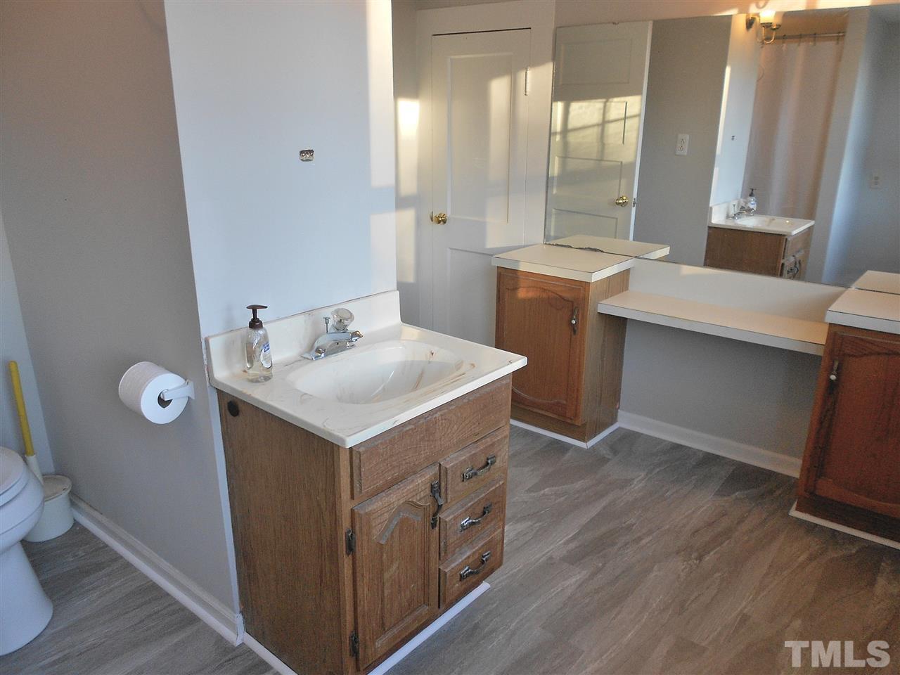 9408 Walter Myatt Road Fuquay-Varina, NC 27526 - Photo 16 of 25 a bathroom with a sink mirror and a toilet