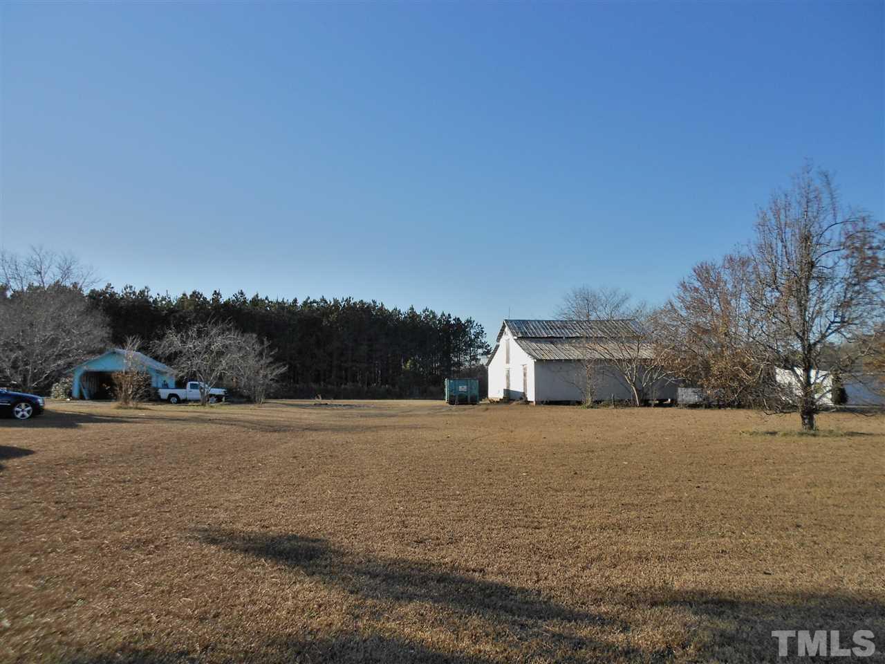9408 Walter Myatt Road Fuquay-Varina, NC 27526 - Photo 3 of 25 a view of dirt road with a building in the background