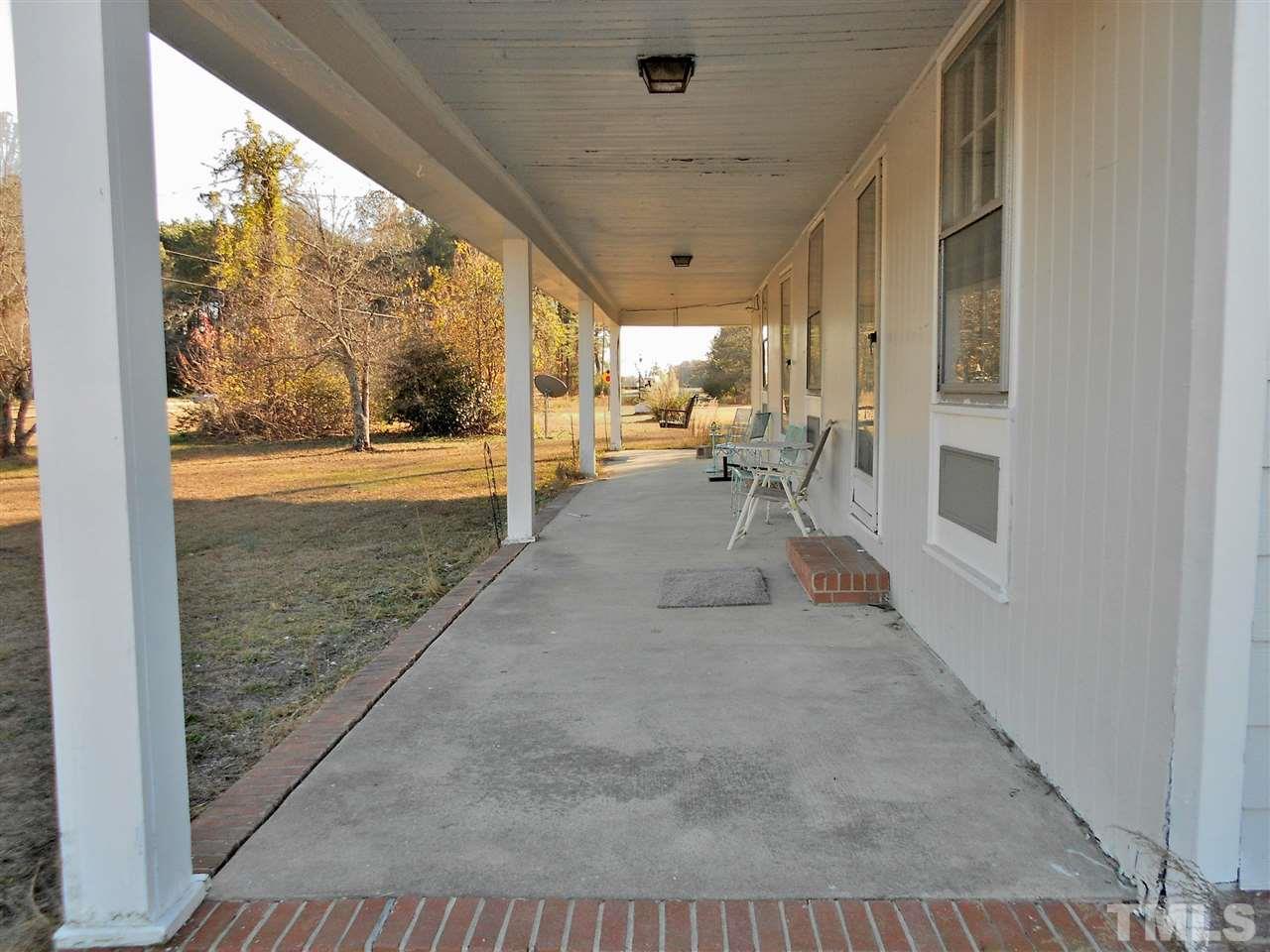 9408 Walter Myatt Road Fuquay-Varina, NC 27526 - Photo 4 of 25 a view of a porch with chairs and backyard
