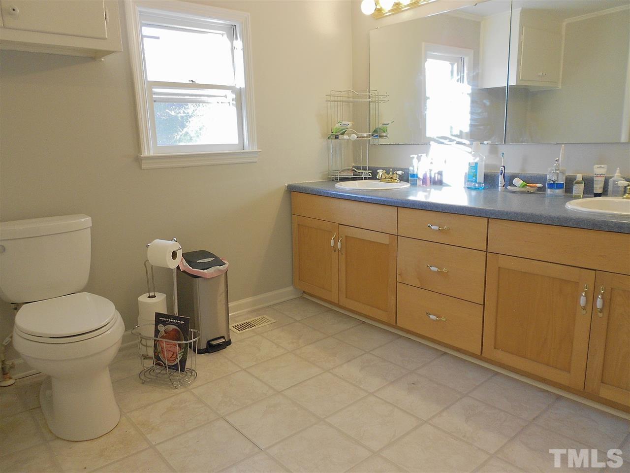 9408 Walter Myatt Road Fuquay-Varina, NC 27526 - Photo 10 of 25 a bathroom with a toilet sink and mirror