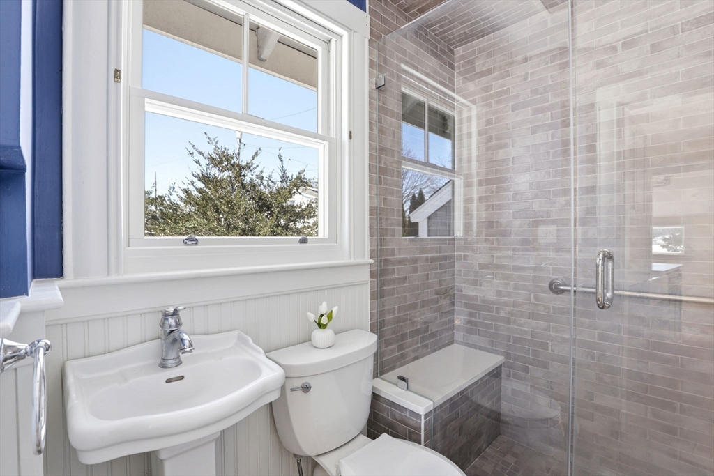 2 Cliff Road Hingham, MA 02043 - Photo 14 of 22 a bathroom with a toilet a sink and a window