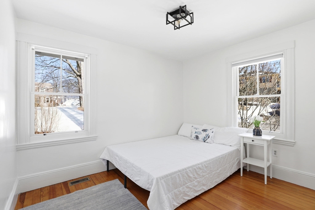 2 Cliff Road Hingham, MA 02043 - Photo 10 of 22 a bedroom with a bed and wooden floor