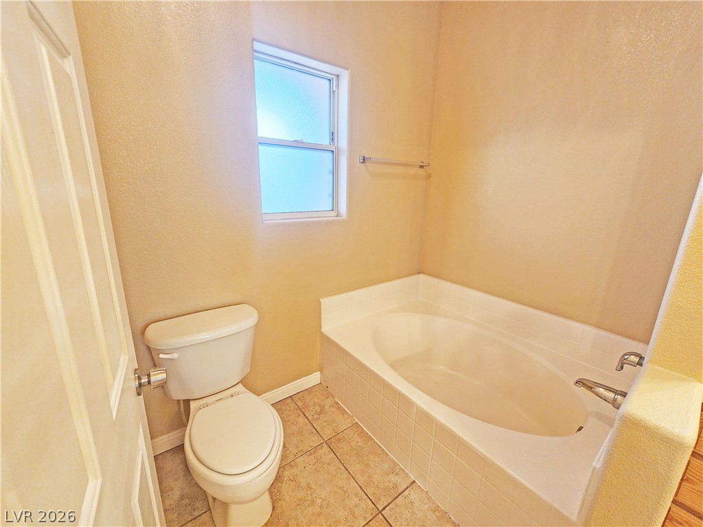1421 Star Road, Unit 2 Pahrump, NV 89048 - Photo 26 of 33 Full bath with baseboards, tile patterned flooring, a garden tub, and toilet
