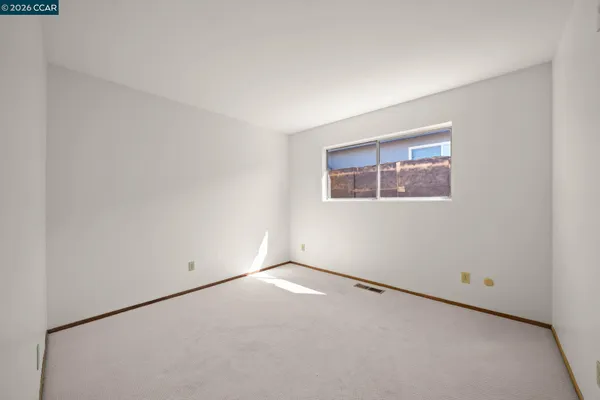 a view of a house with a tree in the background