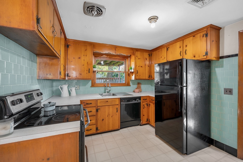 7 Marie Street Methuen, MA 01844 - Photo 4 of 39 a kitchen with stainless steel appliances granite countertop a refrigerator a sink dishwasher stove top oven and cabinets