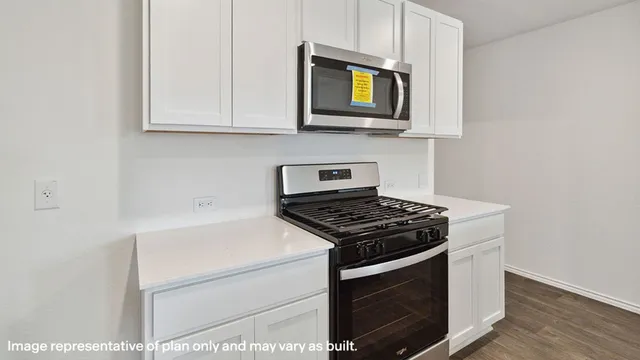 a kitchen with stainless steel appliances granite countertop a stove and a microwave