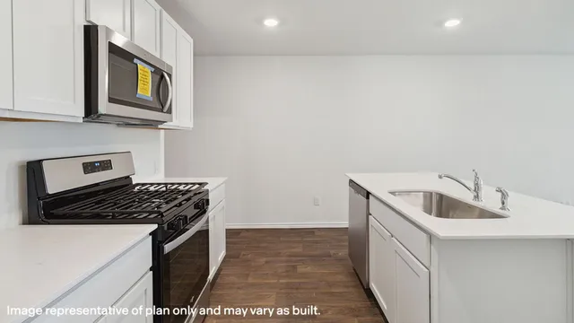 a kitchen with stainless steel appliances granite countertop a sink and cabinets