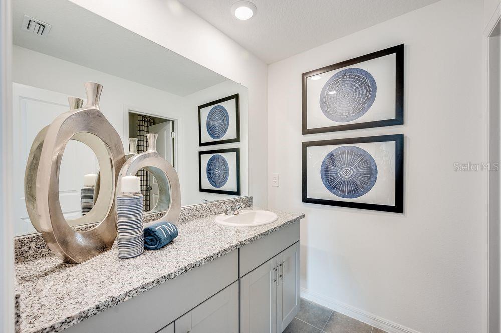 12486 Whisk Court Hudson, FL 34669 - Photo 8 of 29 a bathroom with sink and a mirror