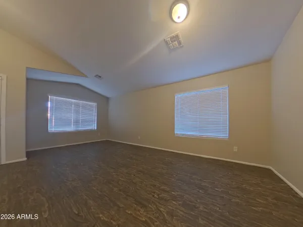 an empty room with a empty space and windows