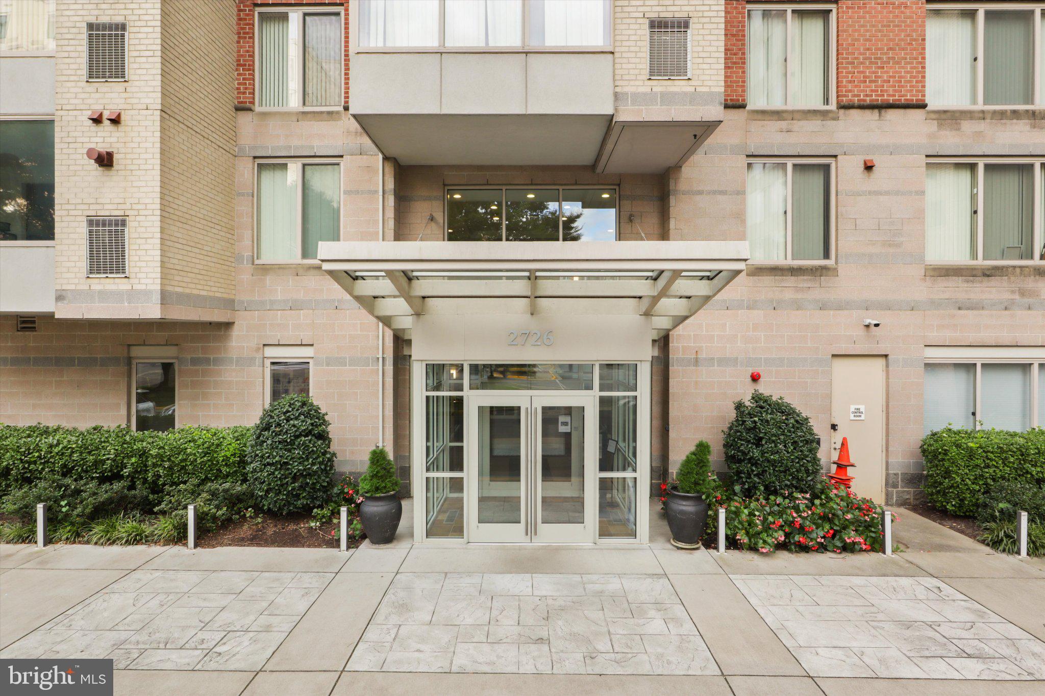 2726 Gallows Road, Unit 1506 Vienna, VA 22180 - Photo 4 of 35 Modern entrance with lush greenery.