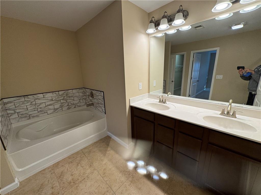4390 Cedar Bridge Walk Suwanee, GA 30024 - Photo 12 of 14 a bathroom with a bathtub sink and mirror