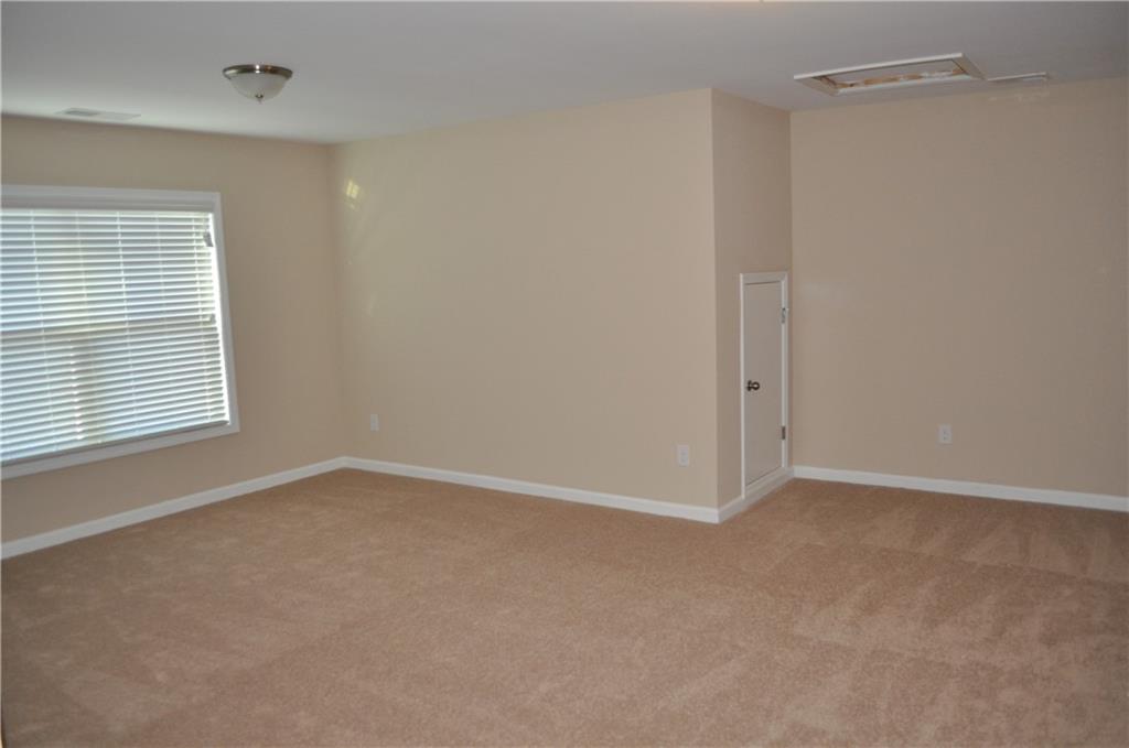 4390 Cedar Bridge Walk Suwanee, GA 30024 - Photo 4 of 14 a view of an empty room with a window
