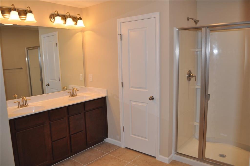 4390 Cedar Bridge Walk Suwanee, GA 30024 - Photo 5 of 14 a bathroom with a double vanity sink mirror and shower