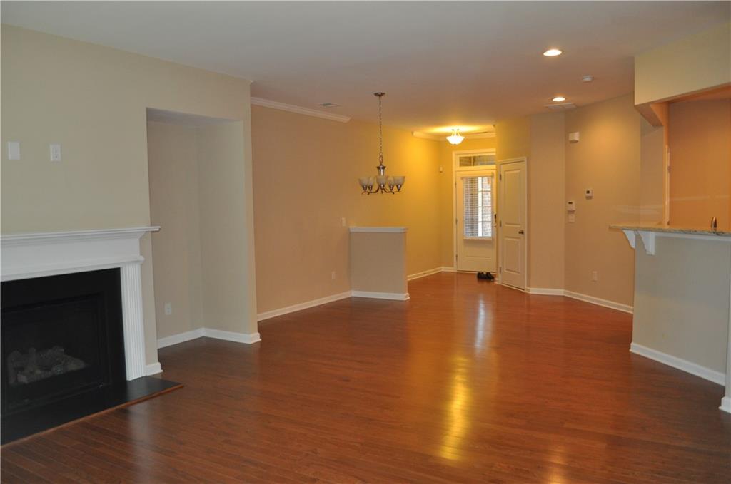 4390 Cedar Bridge Walk Suwanee, GA 30024 - Photo 6 of 14 a view of an empty room with wooden floor and a fireplace