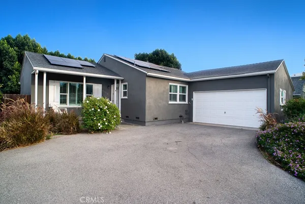 a view of a house with a yard and garage