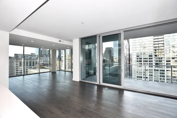 a view of interior space with wooden floor and fan