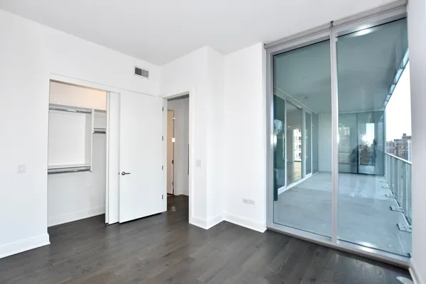 a view of a living room and a floor to ceiling window or wooden floor