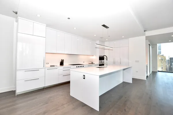 a view of kitchen with stainless steel appliances granite countertop a sink and a refrigerator
