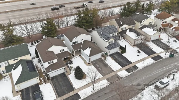 an aerial view of a house with a white walls
