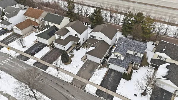 an aerial view of a house with a yard