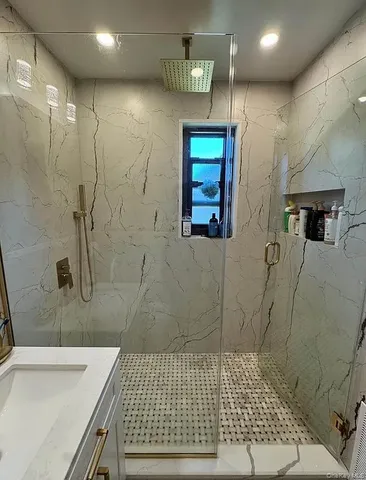 a bathroom with a sink a toilet and shower