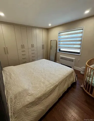 a bed sitting in a bedroom next to a window