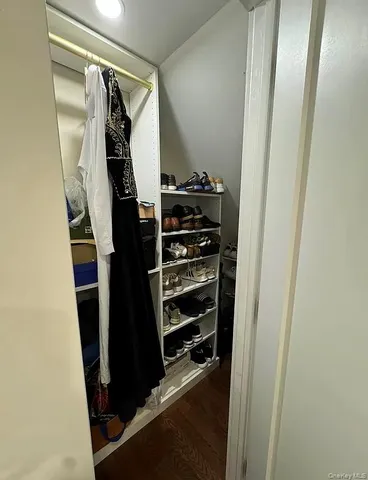 a view of walk in closet with clothes