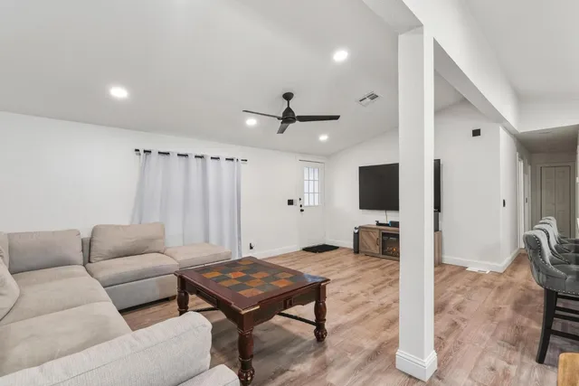a living room with furniture a rug and a flat screen tv