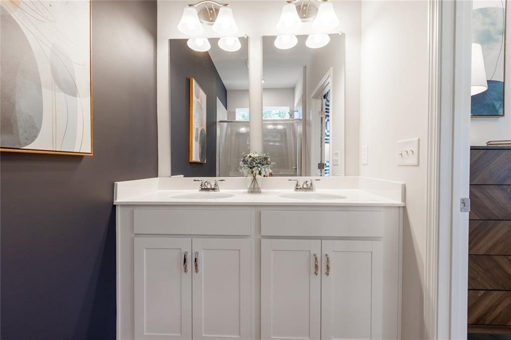 141 Andros Loop Dalton, GA 30721 - Photo 16 of 25 a bathroom with a sink vanity and a mirror