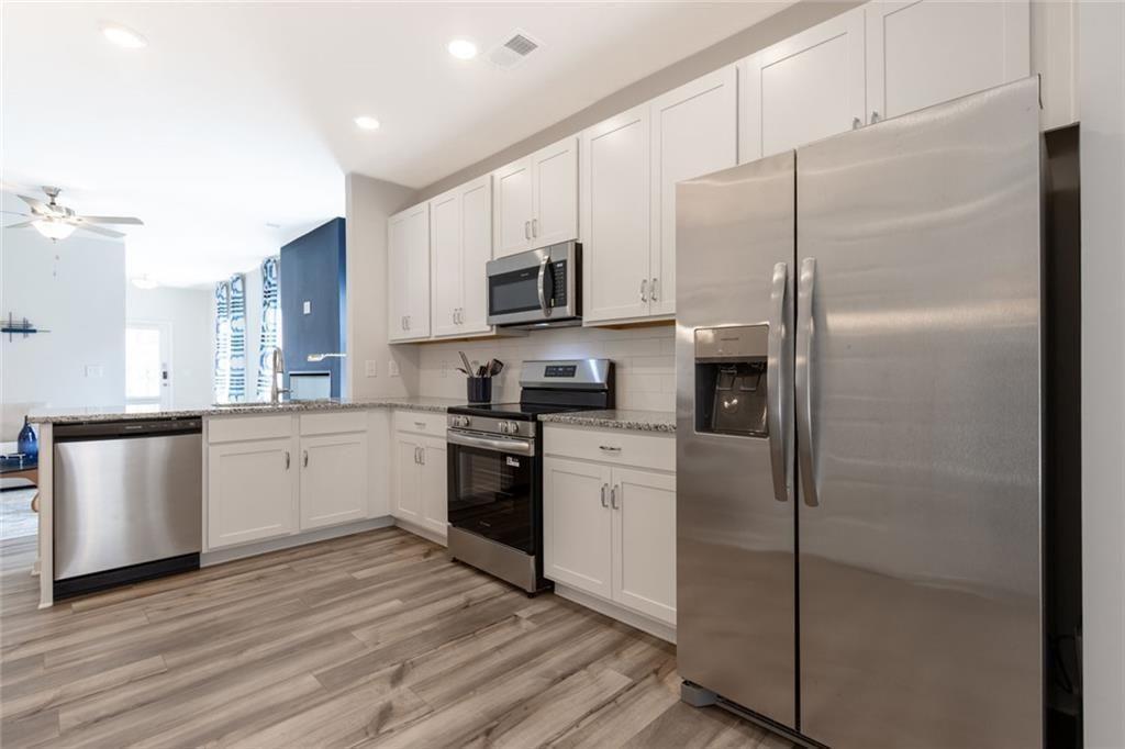 141 Andros Loop Dalton, GA 30721 - Photo 7 of 25 a kitchen with stainless steel appliances a refrigerator sink and stove