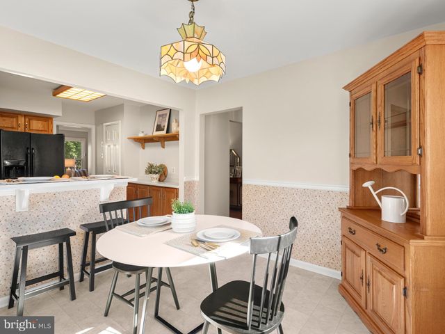 a view of a dining room with furniture and a chandelier