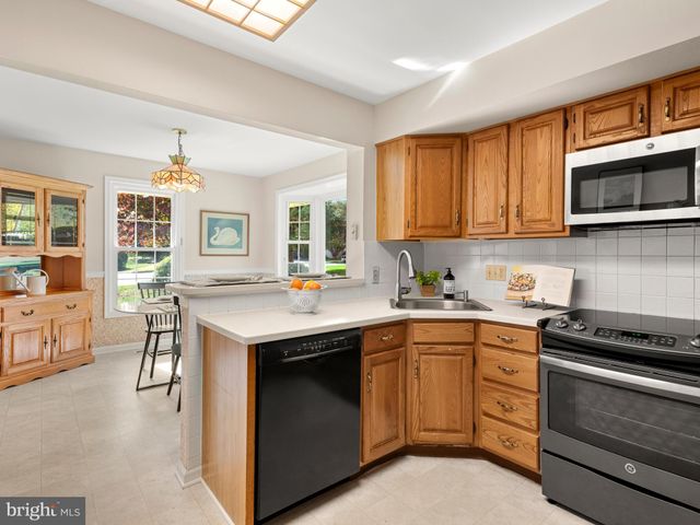 a kitchen with a stove sink and microwave