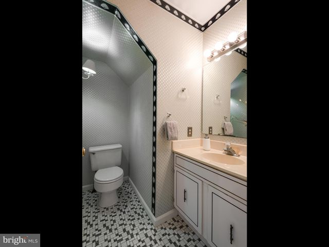 a bathroom with a sink toilet a mirror and vanity