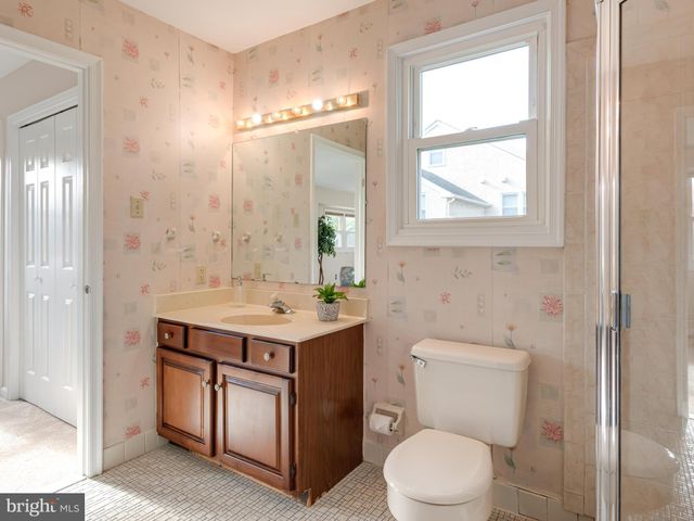 a bathroom with a toilet a sink and a mirror