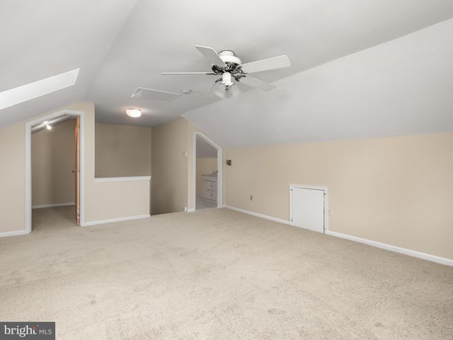a view of a livingroom with a ceiling fan and window