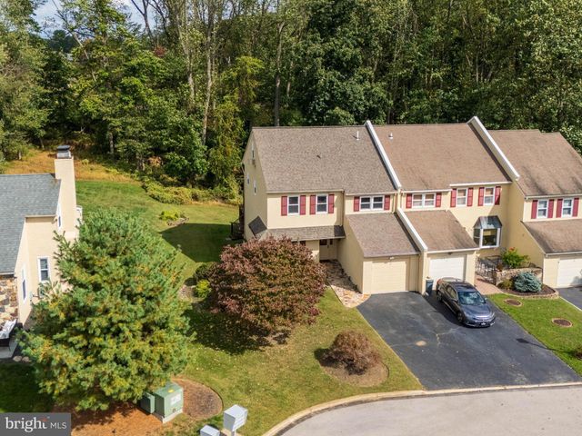an aerial view of a house with a yard basket ball court and outdoor seating
