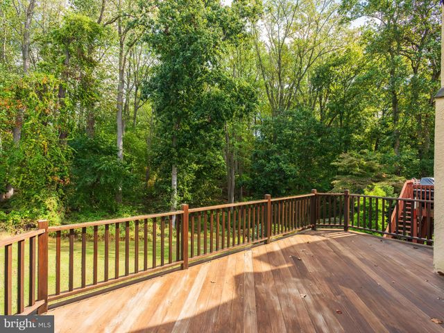 a view of balcony with wooden floor and fence