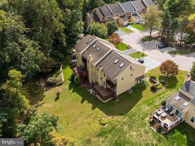 an aerial view of a house with a yard swimming pool and outdoor seating