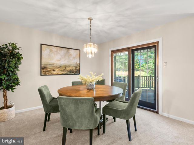 a dining room with furniture a window and a chandelier