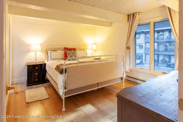 a living room with a flat screen tv and a walk in closet