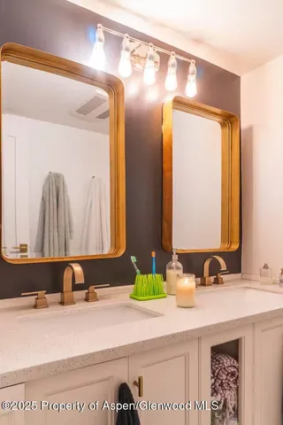 a bathroom with a sink and mirror