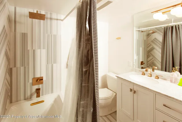 a view of a bathtub with window and a shower