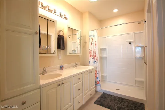 a bathroom with a glass door shower and a toilet